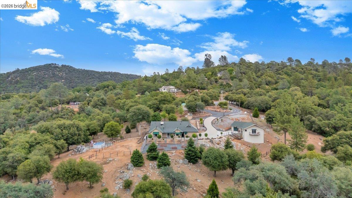 18180 Robin Ridge Road Sonora, CA 95370 - Photo 82 of 88 Expansive property featuring a main residence, secondary structure, paved driveway, and established landscaping