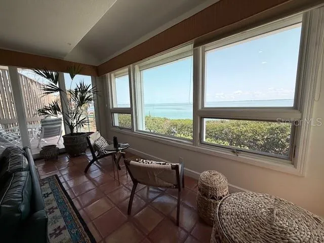 a large bedroom with bed and a large window