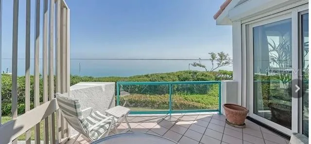 a view of a chair and tables in the balcony