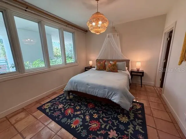 a living room with a couch and a chandelier
