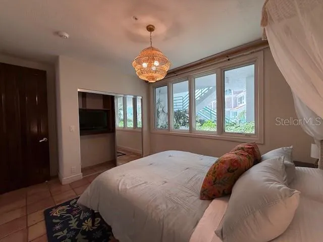 a view of a hallway with wooden floor and a living room