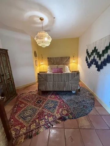 a front view of a house with a yard and potted plants