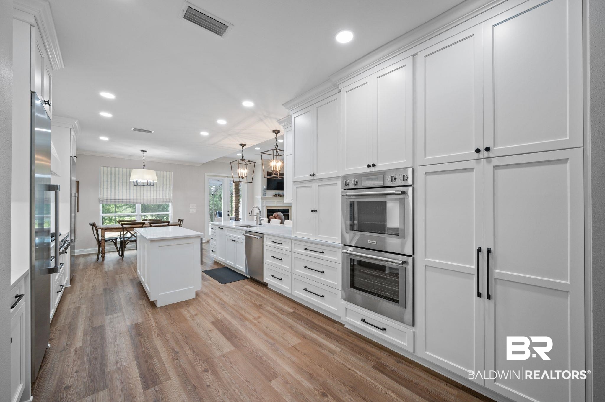 14591 Styx River Road Stapleton, AL 36578 - Photo 14 of 47 Kitchen featuring appliances with stainless steel finishes, white cabinetry, recessed lighting, light countertops, and a sink