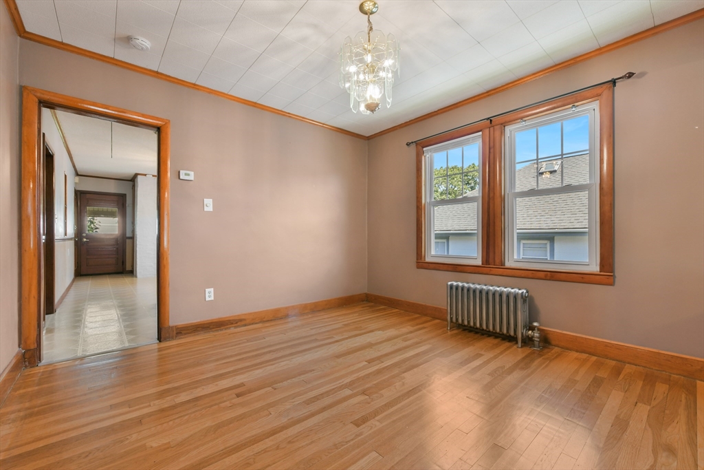 331-333 Vermont Street Boston, MA 02132 - Photo 12 of 26 an empty room with wooden floor and windows