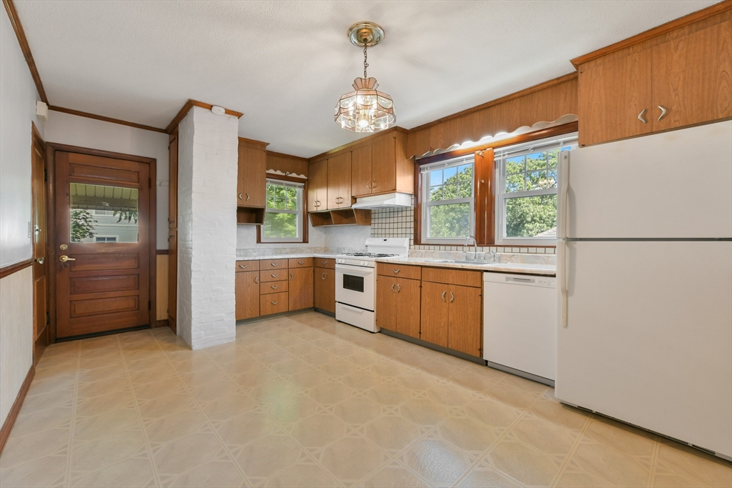331-333 Vermont Street Boston, MA 02132 - Photo 13 of 26 a kitchen with stainless steel appliances a refrigerator sink and cabinets