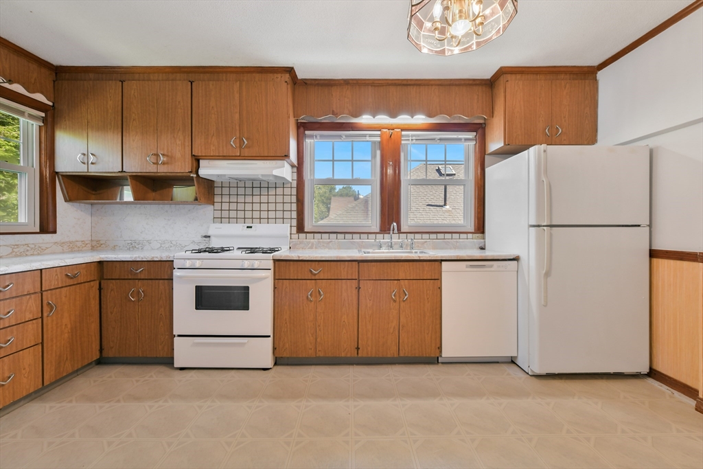 331-333 Vermont Street Boston, MA 02132 - Photo 16 of 26 a kitchen with white cabinets and white appliances
