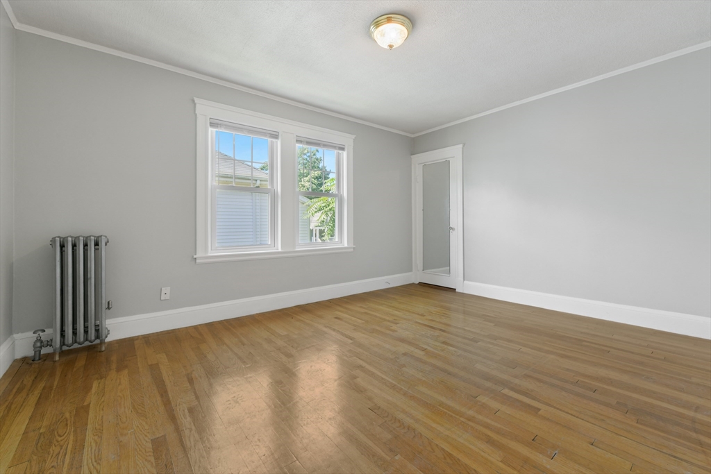331-333 Vermont Street Boston, MA 02132 - Photo 17 of 26 an empty room with wooden floor and windows