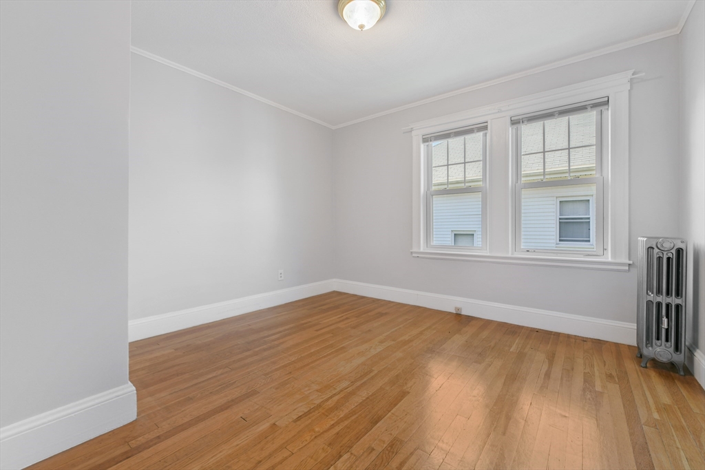 331-333 Vermont Street Boston, MA 02132 - Photo 19 of 26 an empty room with wooden floor and windows