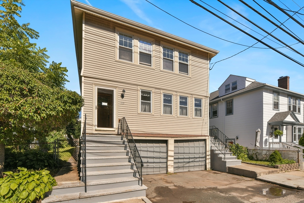 331-333 Vermont Street Boston, MA 02132 - Photo 2 of 26 a front view of a house with a yard