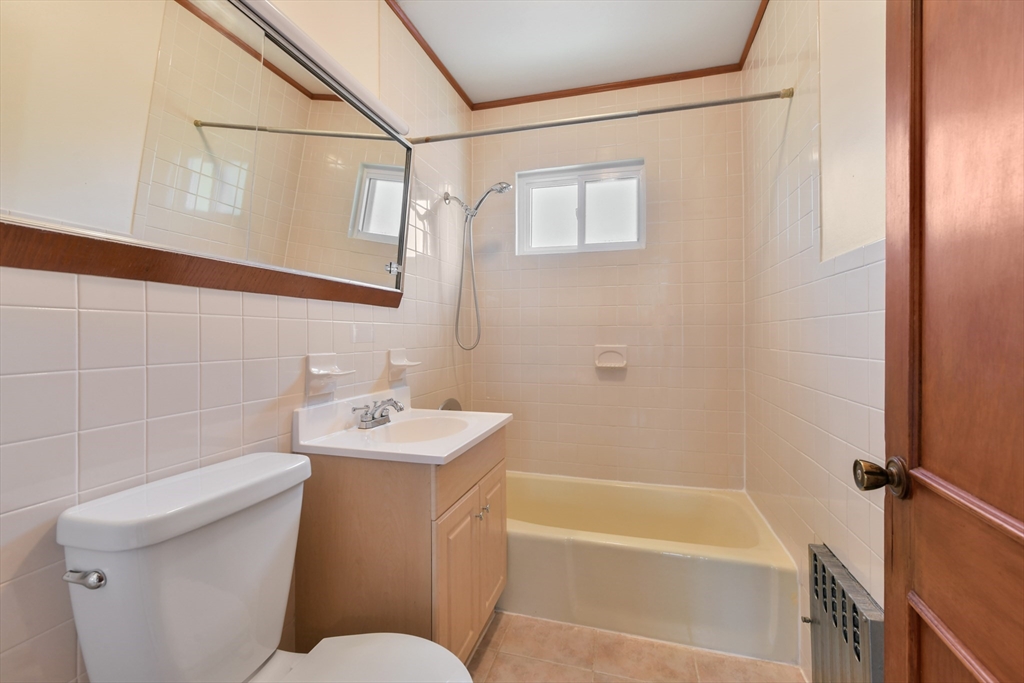 331-333 Vermont Street Boston, MA 02132 - Photo 21 of 26 a bathroom with a sink a toilet and shower