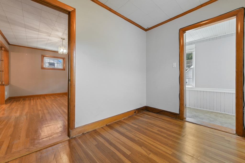 331-333 Vermont Street Boston, MA 02132 - Photo 22 of 26 a view of an empty room with wooden floor and a window