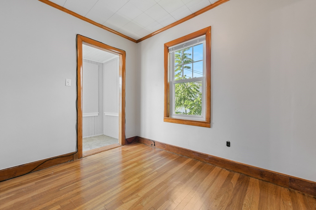 331-333 Vermont Street Boston, MA 02132 - Photo 23 of 26 an empty room with wooden floor and windows