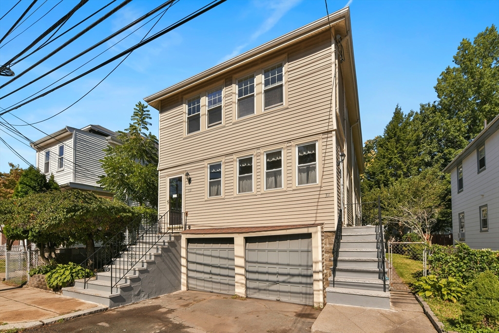 331-333 Vermont Street Boston, MA 02132 - Photo 3 of 26 a front view of a house with a garage