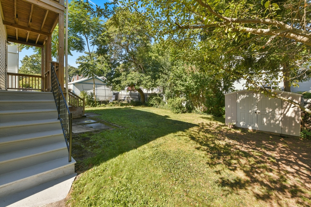 331-333 Vermont Street Boston, MA 02132 - Photo 4 of 26 a view of a yard with plants and a bench