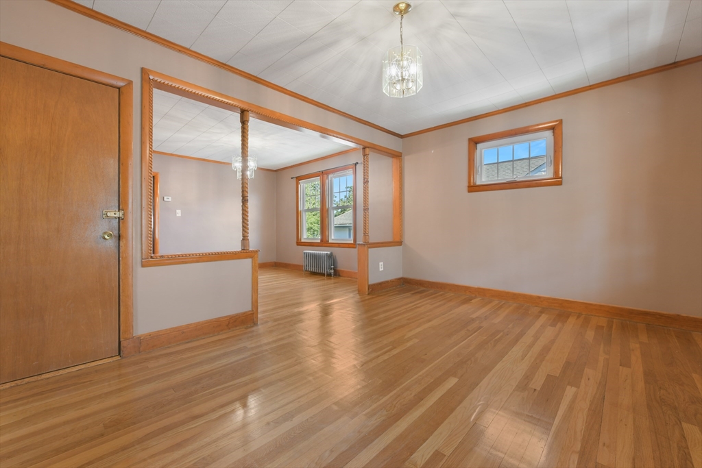 331-333 Vermont Street Boston, MA 02132 - Photo 7 of 26 a view of an empty room with wooden floor and a window