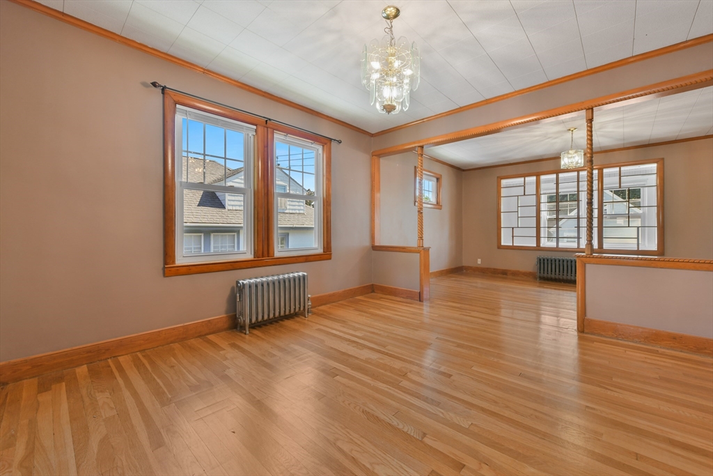 331-333 Vermont Street Boston, MA 02132 - Photo 10 of 26 a view of an empty room with wooden floor and a window