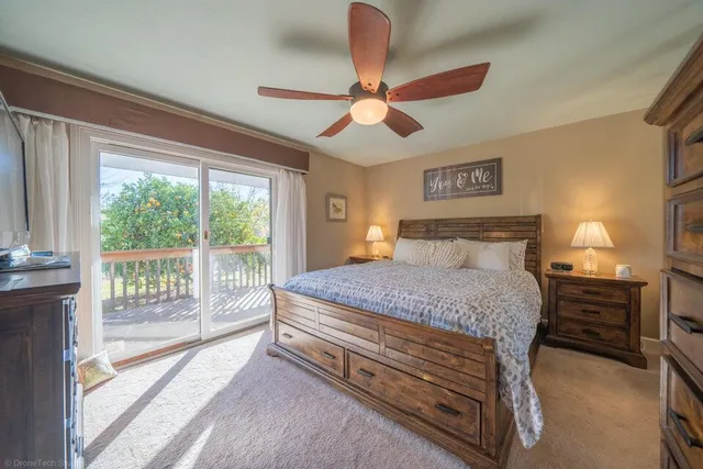 a bedroom with a balcony a bed and a chandelier