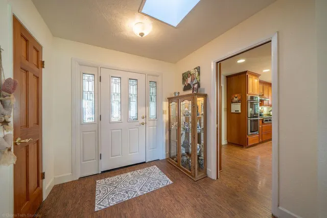 a view of a livingroom with wooden floor and cabinet