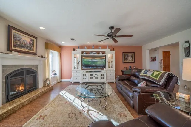 a living room with furniture a window and a fireplace