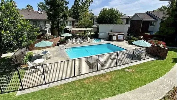 a view of a backyard with furniture and a garden