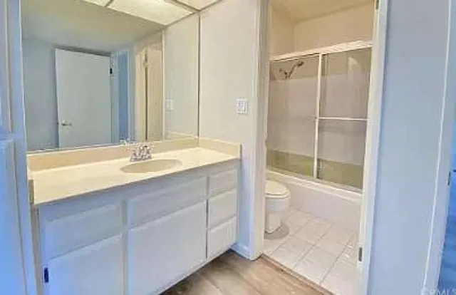 a bathroom with a shower sink and mirror