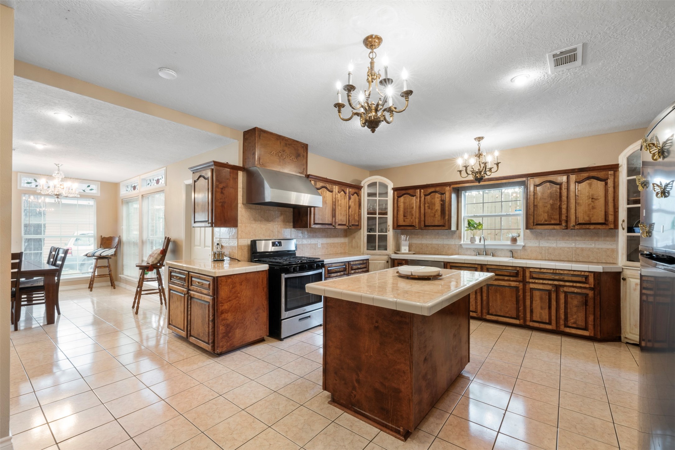 6900 Gregdale Road Houston, TX 77049 - Photo 15 of 49 a kitchen with stainless steel appliances granite countertop a sink counter space and living room view