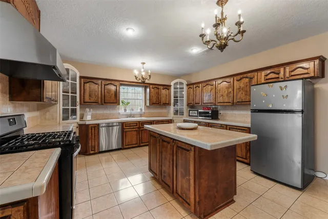a kitchen with a stove sink and refrigerator