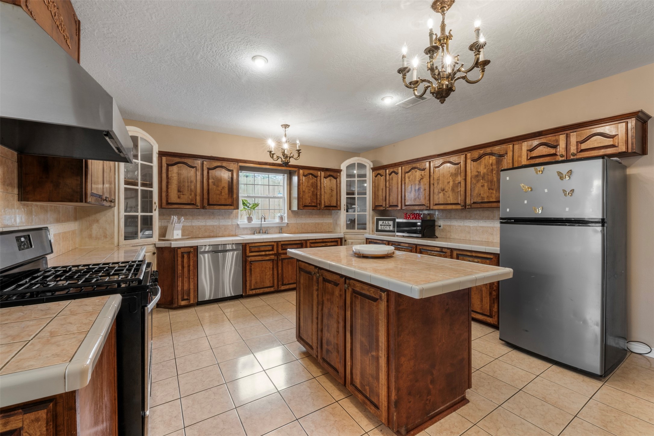 6900 Gregdale Road Houston, TX 77049 - Photo 17 of 49 a kitchen with a stove sink and refrigerator