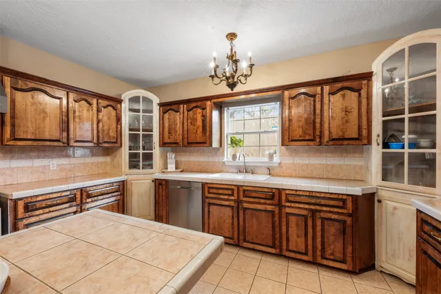 a large kitchen with stainless steel appliances granite countertop a sink and cabinets