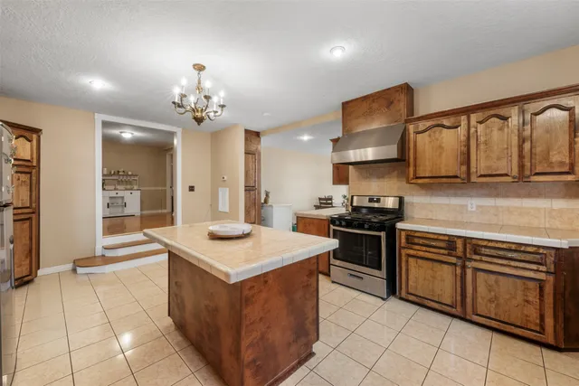 a kitchen with stainless steel appliances granite countertop a sink and cabinets