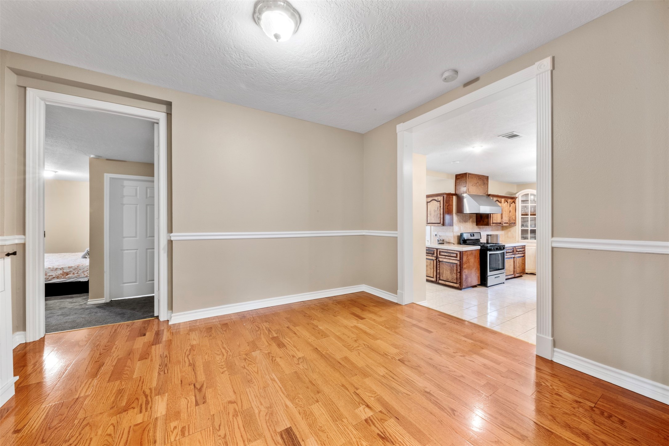 6900 Gregdale Road Houston, TX 77049 - Photo 23 of 49 a view of a livingroom with wooden floor and a flat screen tv