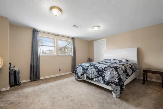 a bedroom with a bed and window