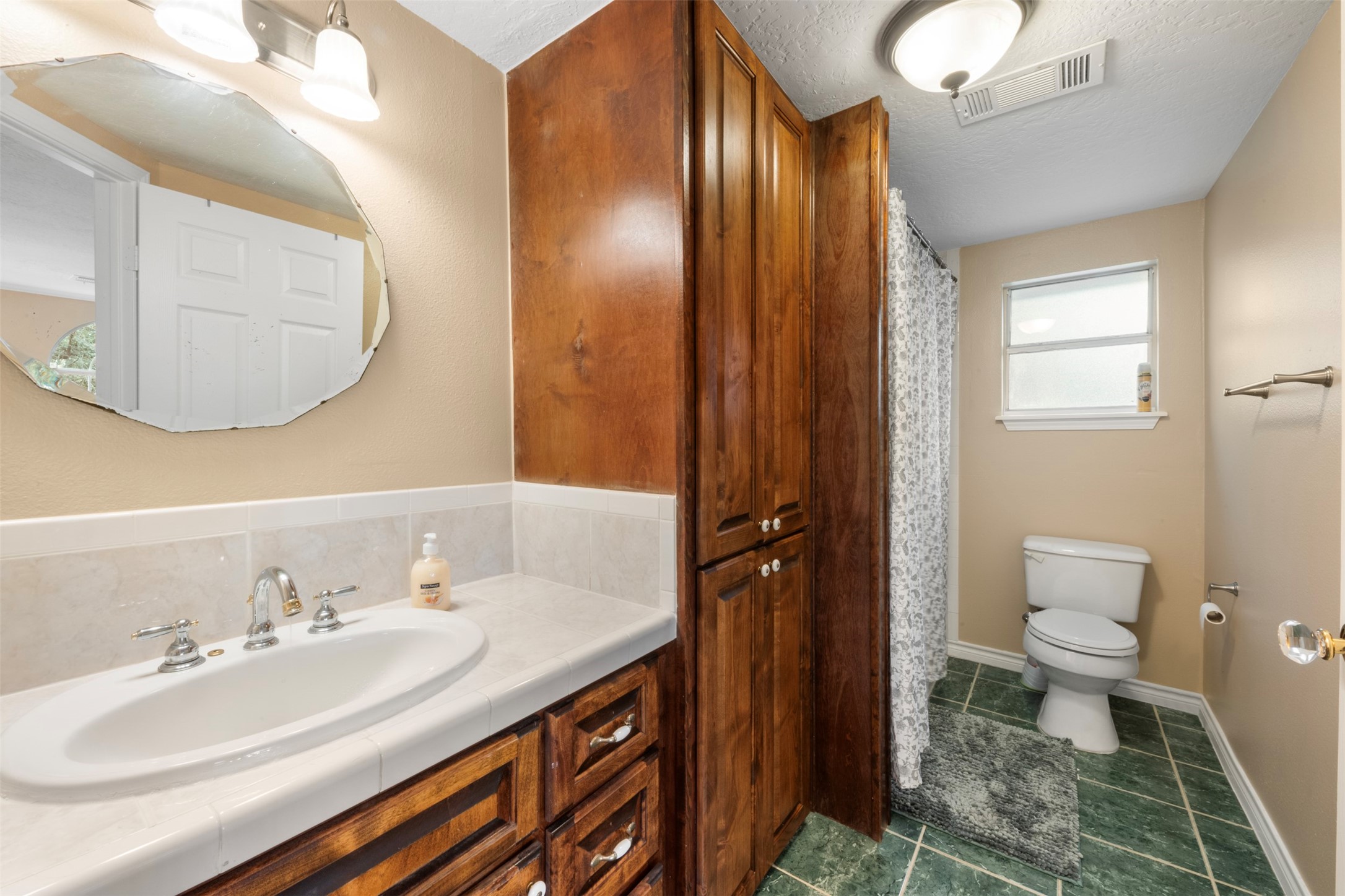 6900 Gregdale Road Houston, TX 77049 - Photo 33 of 49 a bathroom with a sink a toilet and a mirror