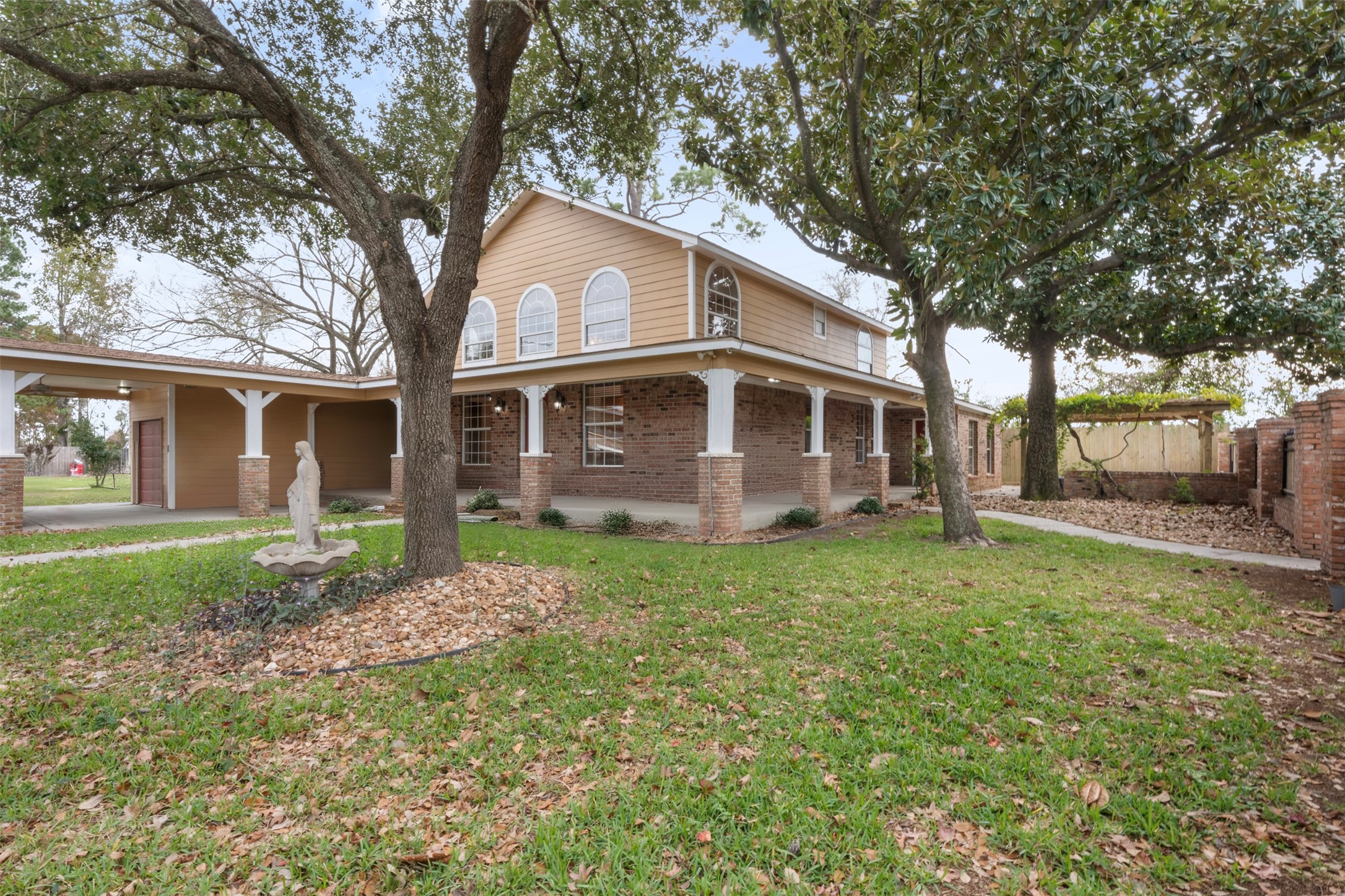 6900 Gregdale Road Houston, TX 77049 - Photo 4 of 49 a house that has a tree in front of the house