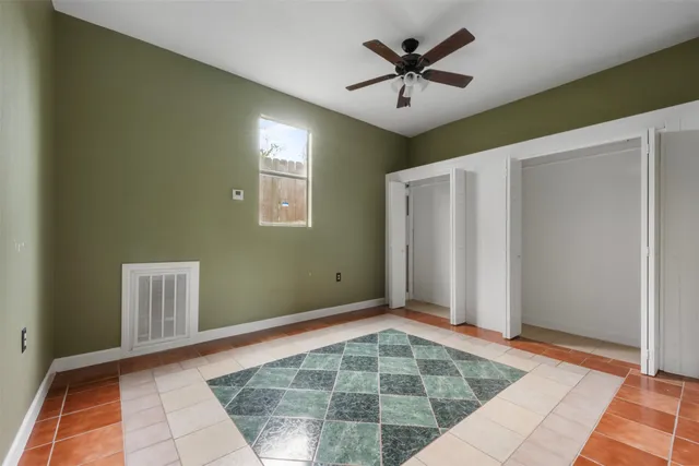 a view of a hallway with a chandelier fan