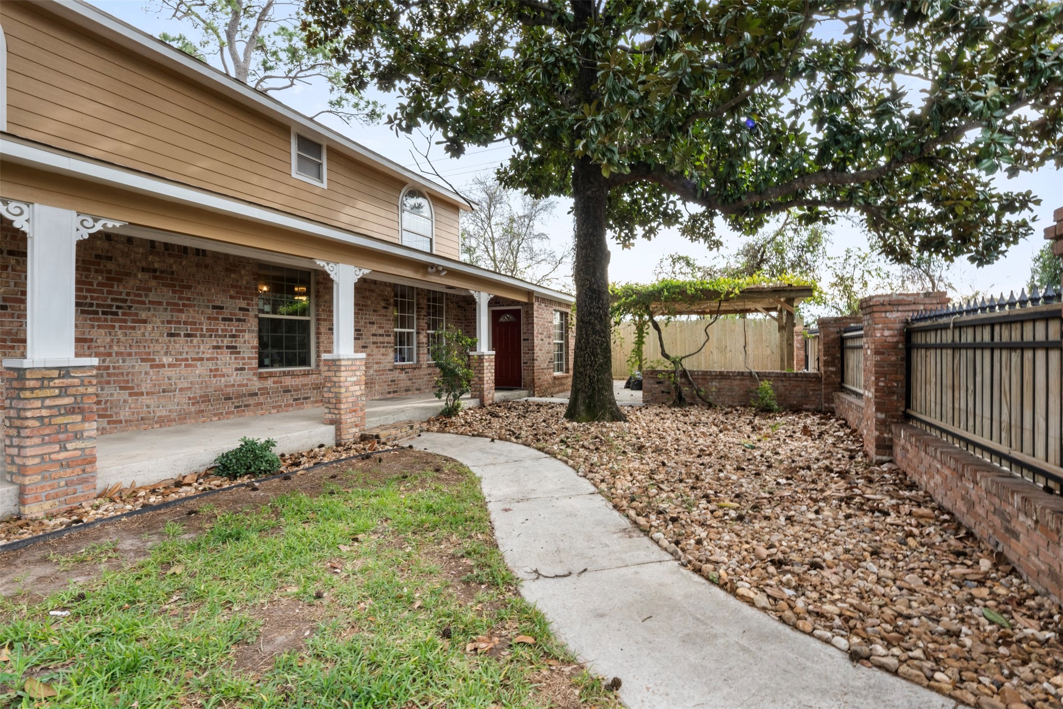 6900 Gregdale Road Houston, TX 77049 - Photo 5 of 49 a front view of a house with a garden