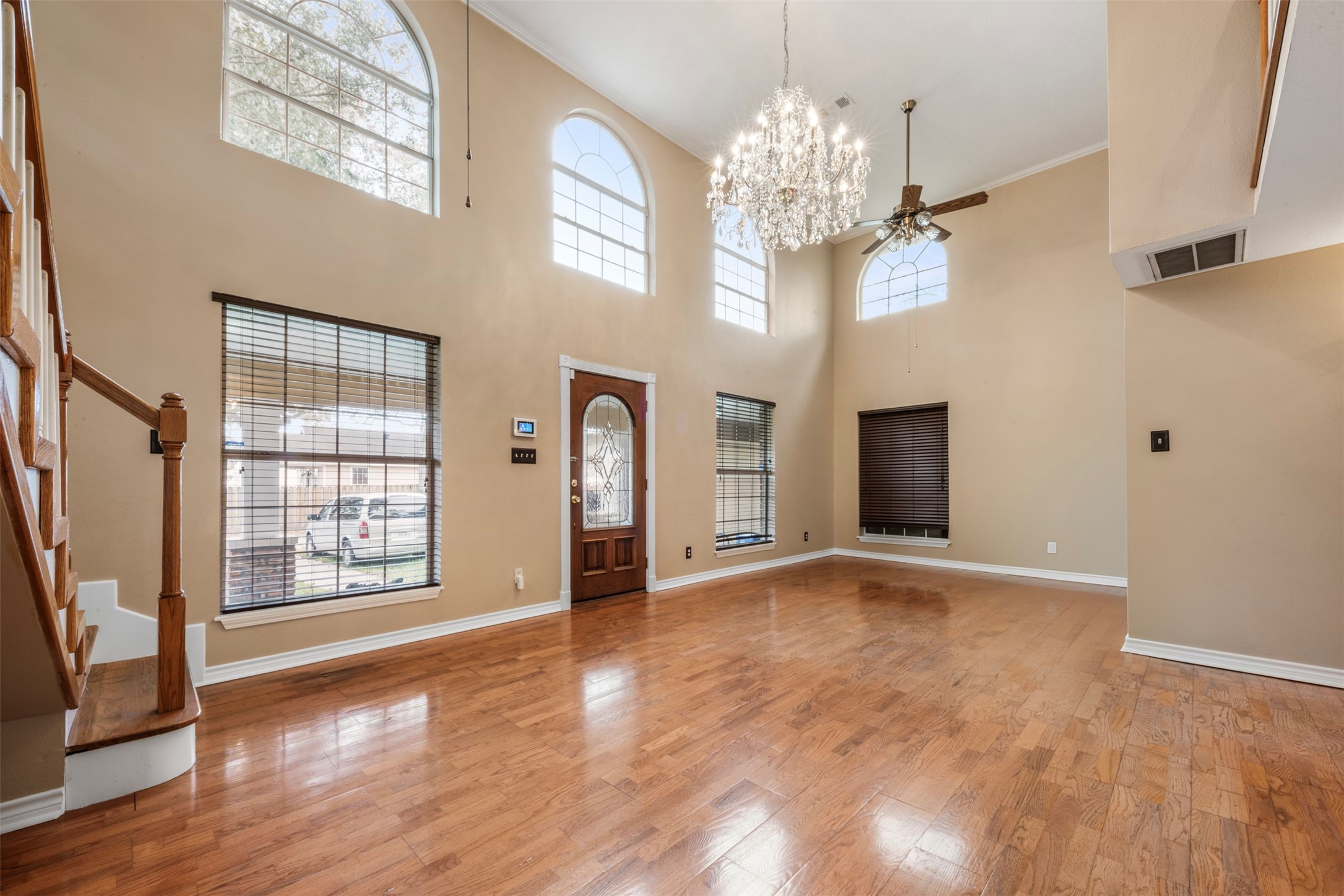 6900 Gregdale Road Houston, TX 77049 - Photo 6 of 49 a view of an empty room with a window and wooden floor