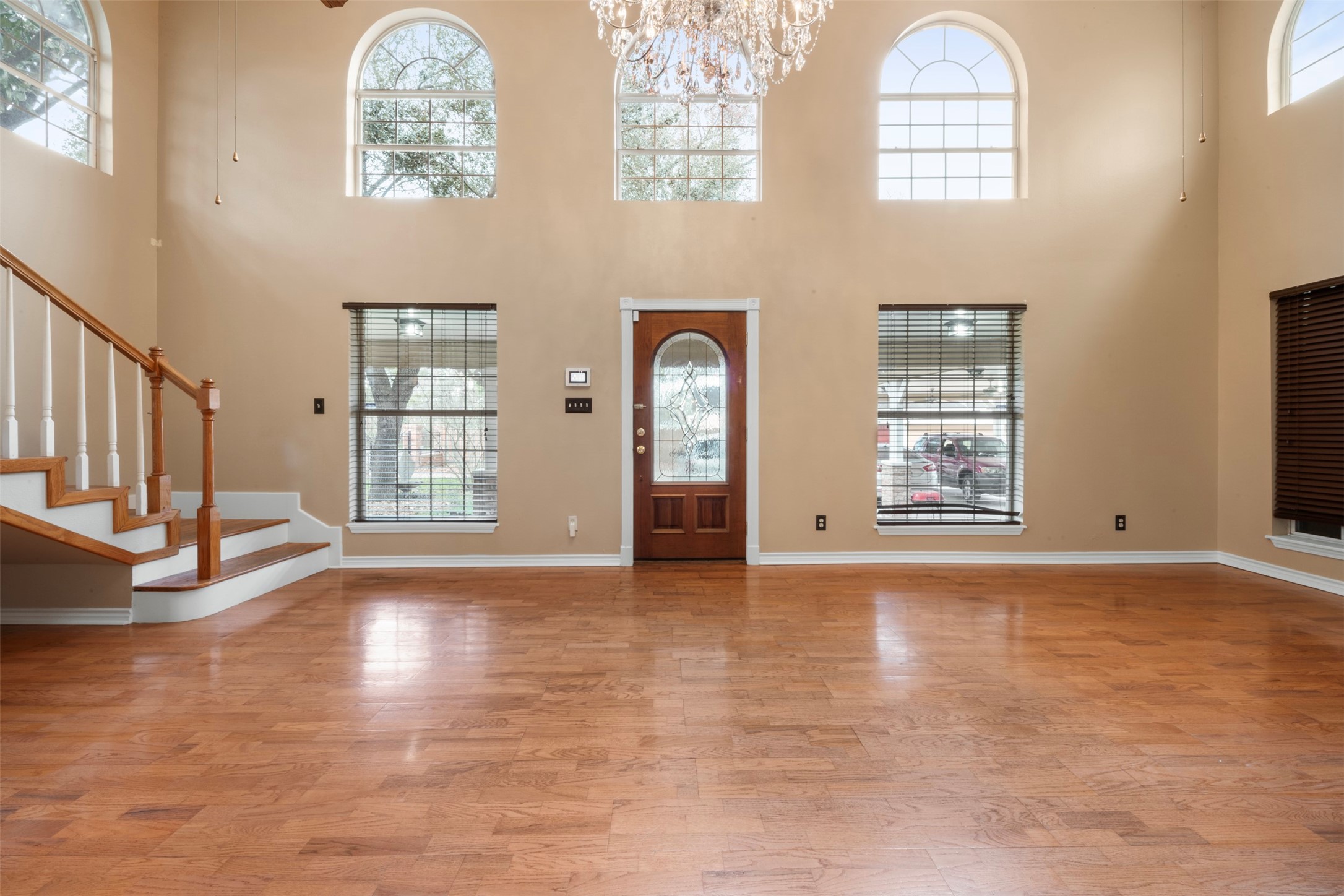 6900 Gregdale Road Houston, TX 77049 - Photo 8 of 49 a view of an empty room with a window and wooden floor