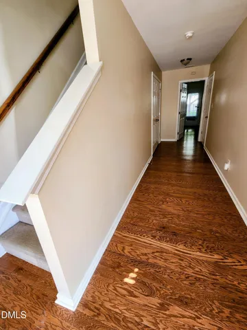 a view of hallway with wooden floor