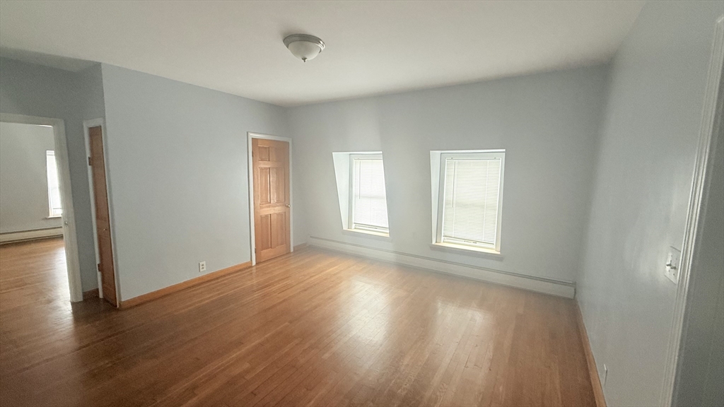 783 2nd Street, Unit 3 Fall River, MA 02721 - Photo 1 of 1 a view of an empty room with wooden floor and a window