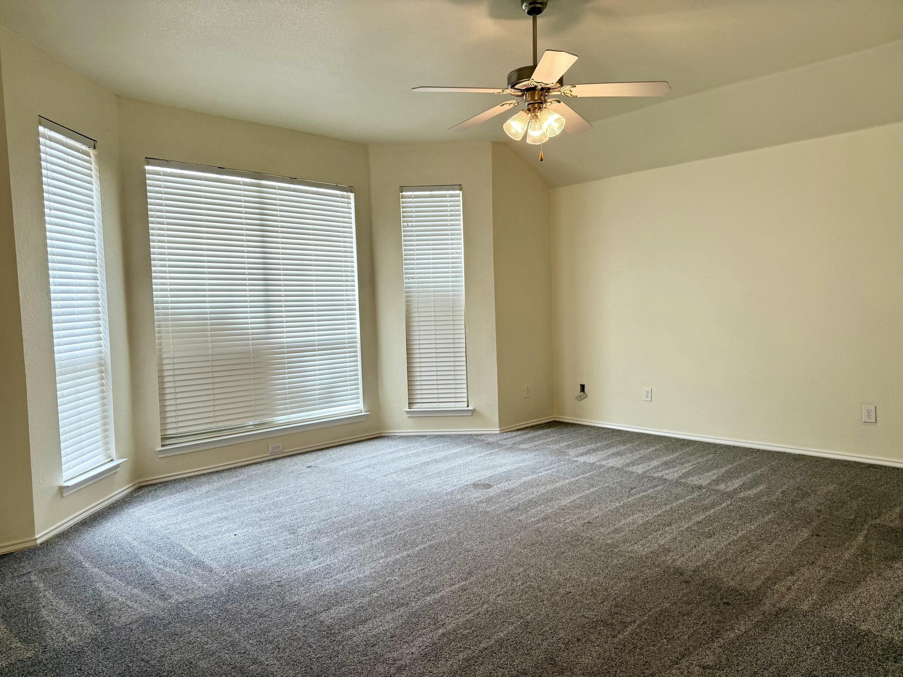 4916 Harvard Drive Lubbock, TX 79416 - Photo 12 of 22 an empty room with windows and fan