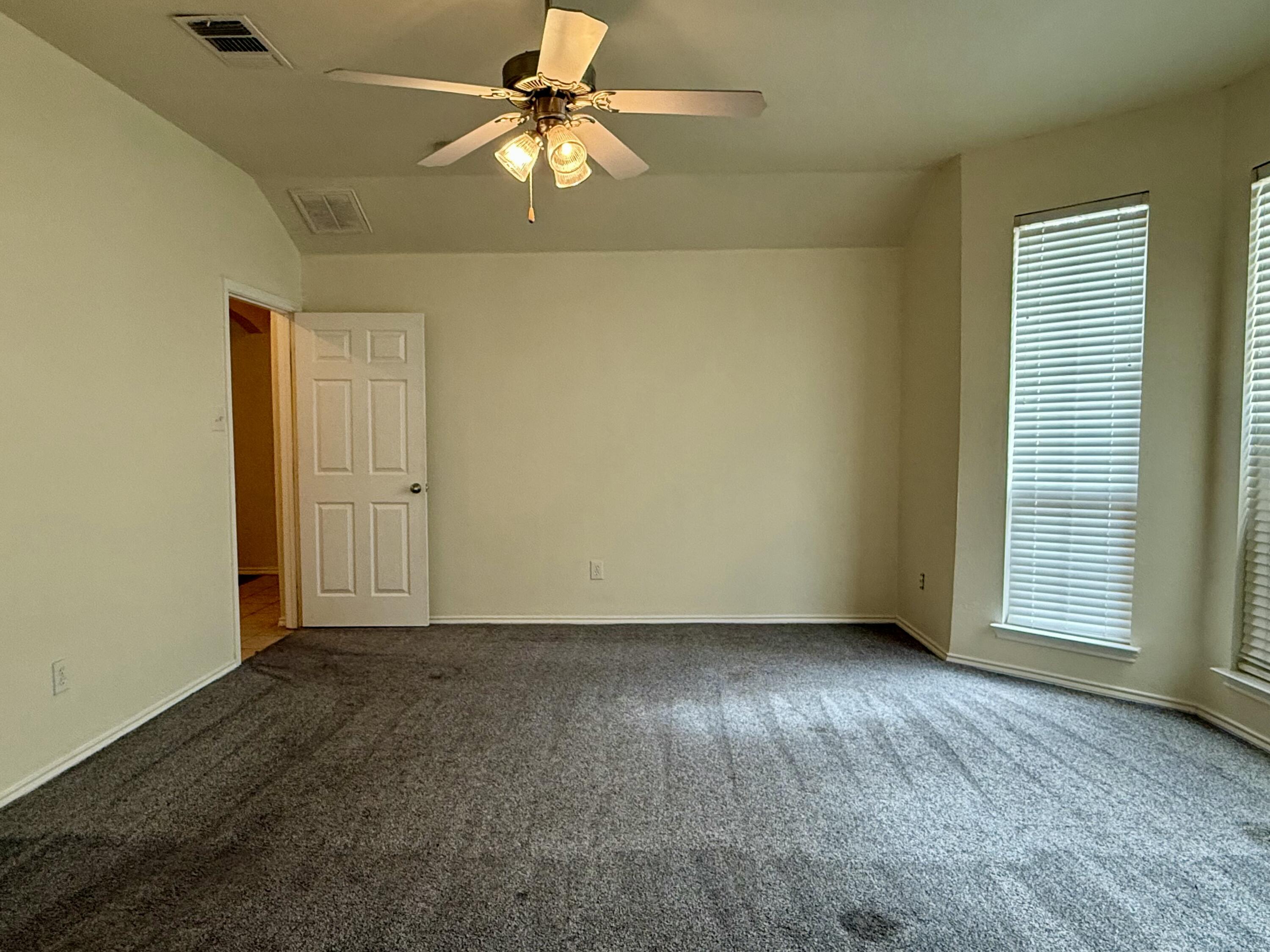 4916 Harvard Drive Lubbock, TX 79416 - Photo 13 of 22 an empty room with windows and fan
