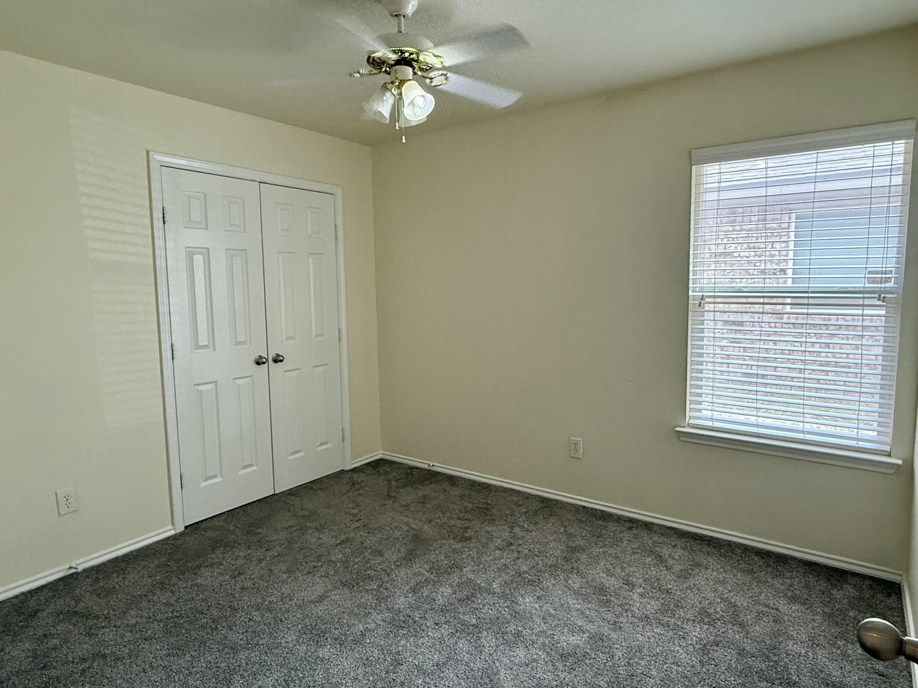 4916 Harvard Drive Lubbock, TX 79416 - Photo 17 of 22 an empty room with a window and a fan