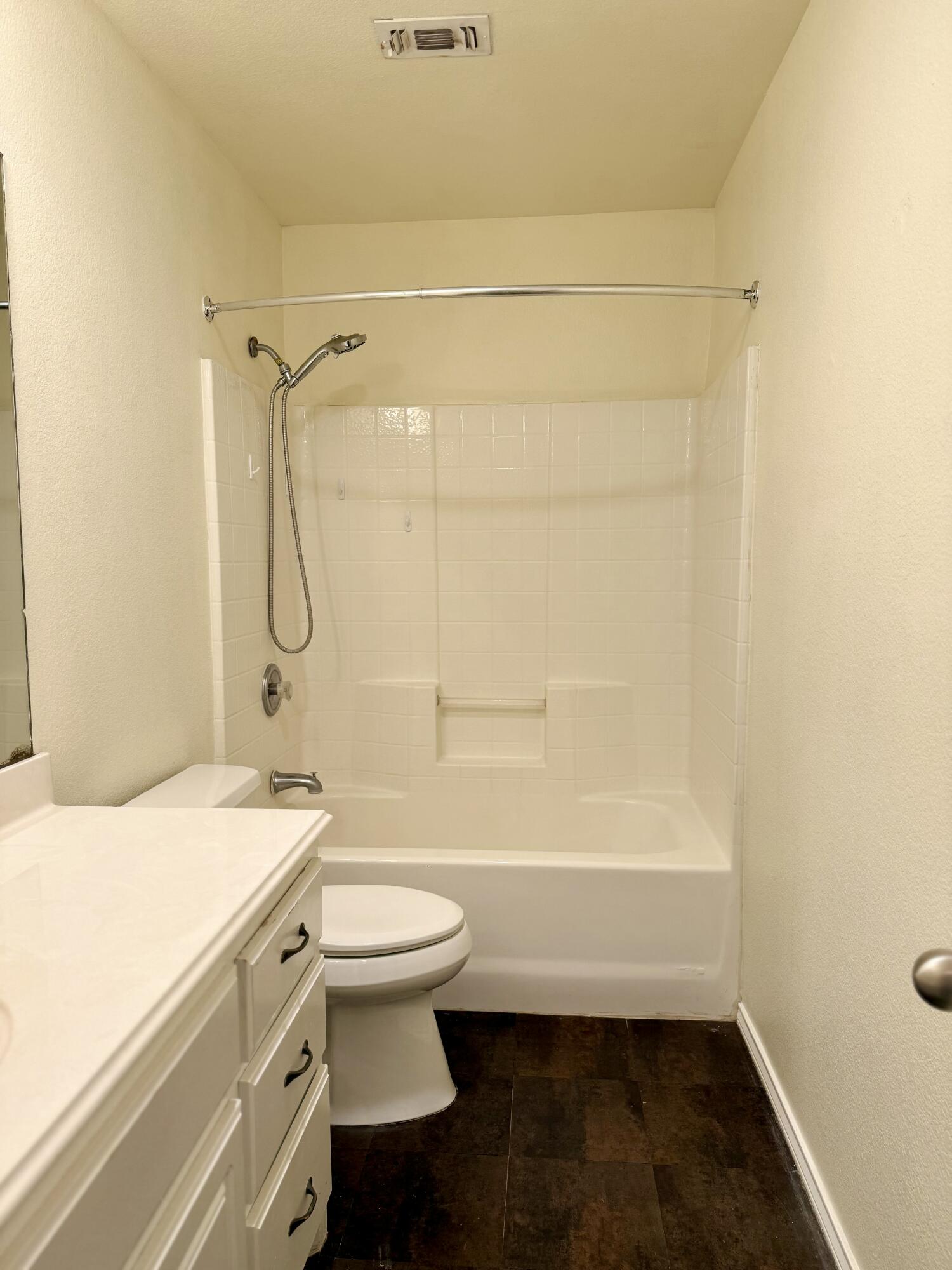 4916 Harvard Drive Lubbock, TX 79416 - Photo 19 of 22 a bathroom with a granite countertop sink toilet and shower