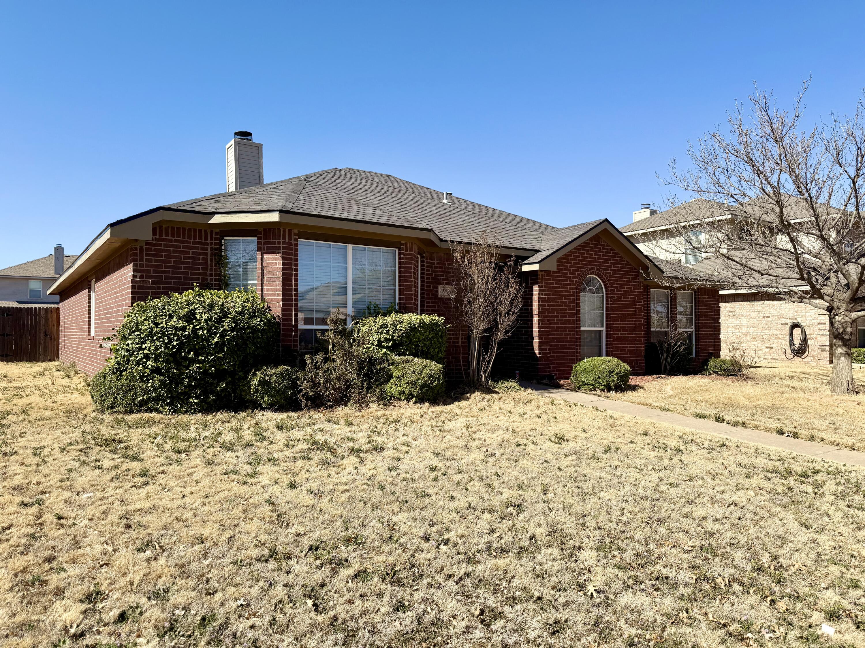 4916 Harvard Drive Lubbock, TX 79416 - Photo 2 of 22 a front view of a house with a yard