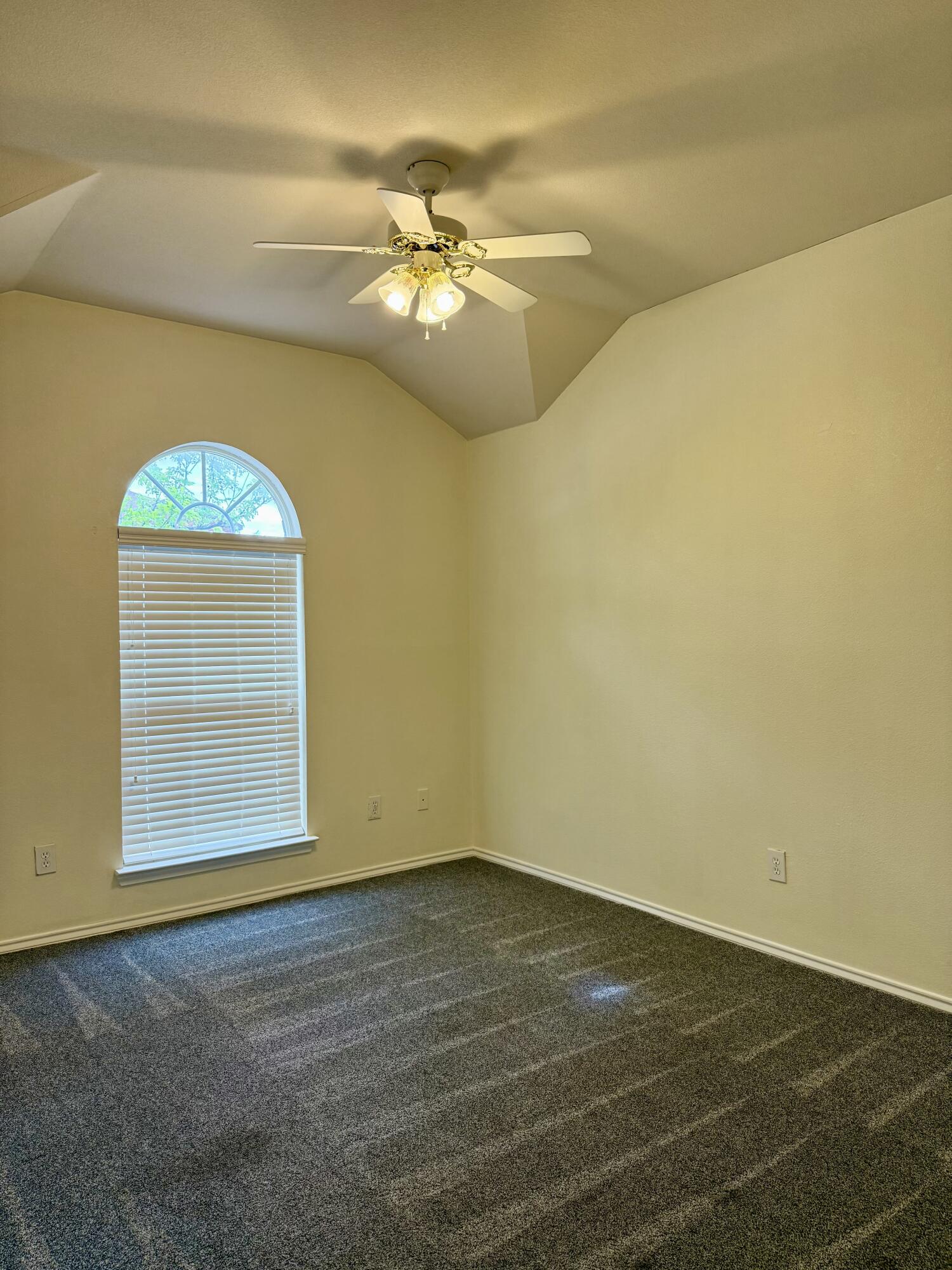 4916 Harvard Drive Lubbock, TX 79416 - Photo 21 of 22 en empty room with wooden floor fan and window