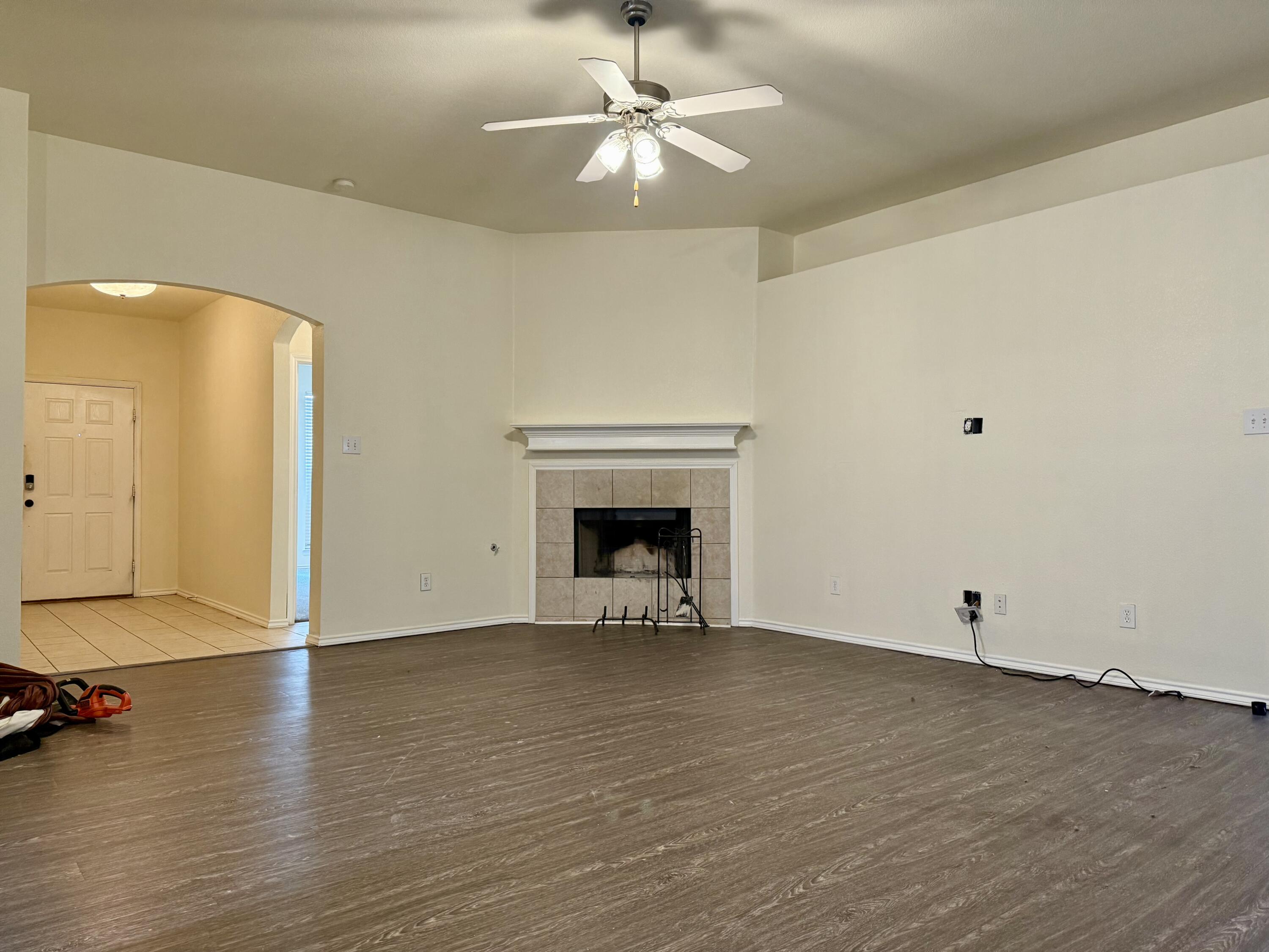 4916 Harvard Drive Lubbock, TX 79416 - Photo 5 of 22 a view of an empty room with window and wooden floor
