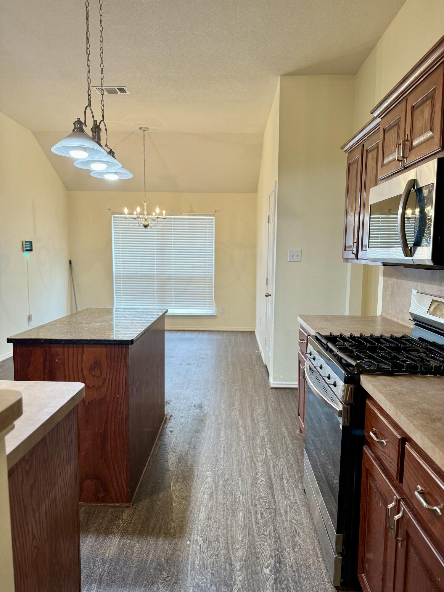 4916 Harvard Drive Lubbock, TX 79416 - Photo 9 of 22 a kitchen with wooden floors and a stove