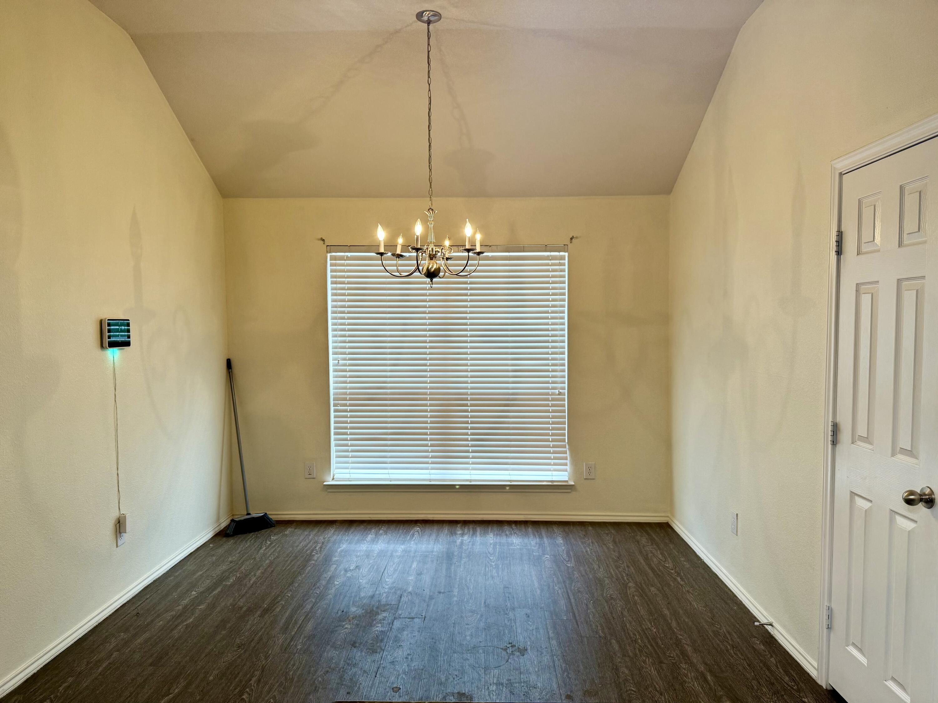 4916 Harvard Drive Lubbock, TX 79416 - Photo 10 of 22 a view of a room with wooden floor staircase and a living room
