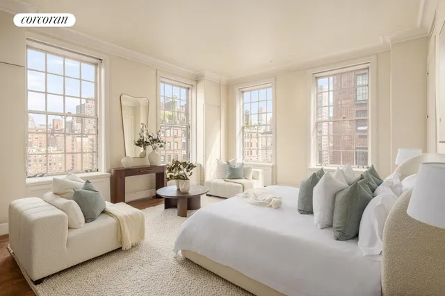 a dining room with furniture and a large window